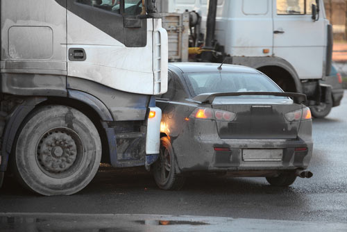 A commercial truck hitting a car