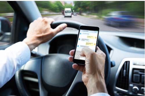Texting and driving, concept of Macon distracted driving accident lawyer