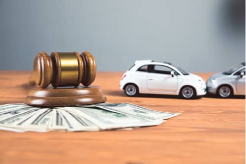 Concept of Perry car accident lawyer, toy cars with money and judge gavel