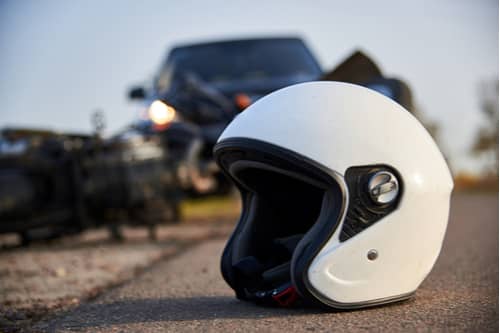 concept of Warner Robbins motorcycle accident lawyer, helmet on road