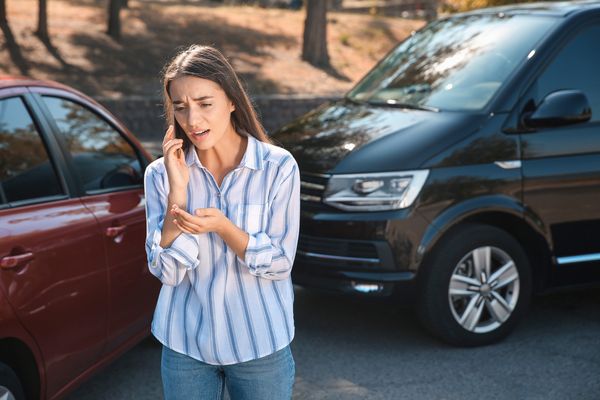 A woman calling her insurance after an accident