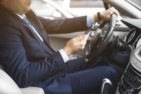 a man texting and driving about to cause an accident the will cause the need for a Gwinnett Texting and Driving Accident Lawyer