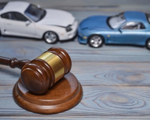 Toy cars in a head-on crash and a judge gavel